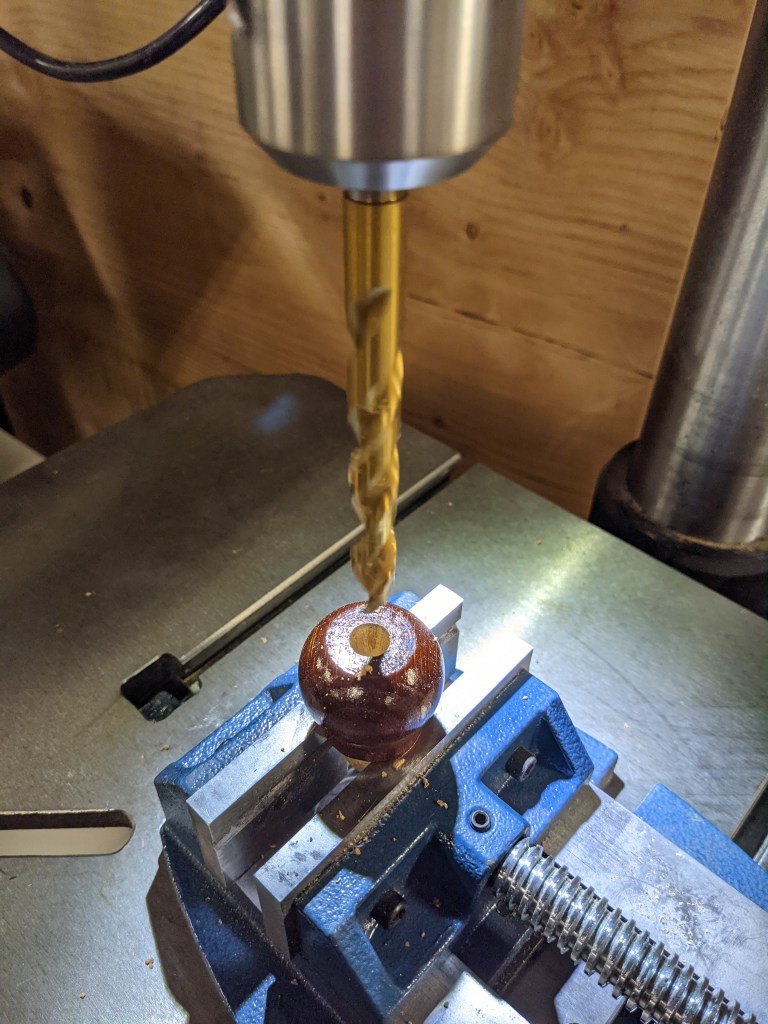 Drilling the cork on the drill-press.