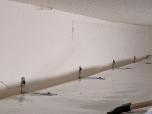 5) Secured to the wall at each stud